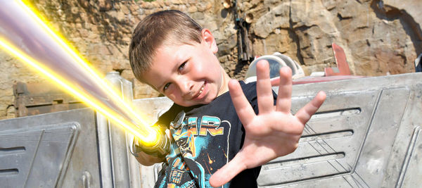 Portrait of boy playing with arms crossed