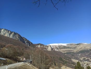 Scenic view of mountains against clear blue sky