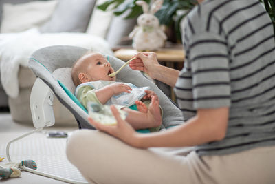 Midsection of woman holding baby