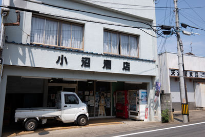 Vehicles on road by buildings in city