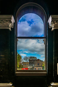 Cloudy sky seen through glass window