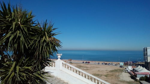 Scenic view of beach against clear blue sky