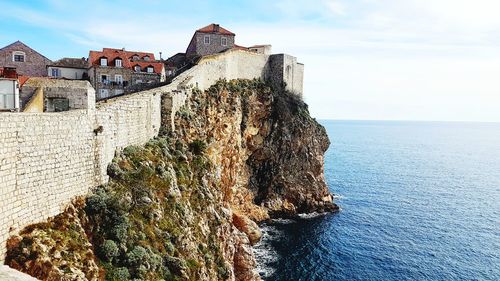 Panoramic view of sea and buildings against sky