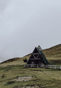 Built structure on field against sky