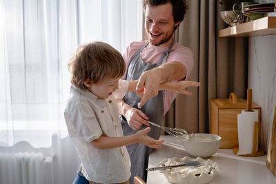 Father and son standing in bowl