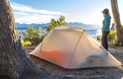 Woman relaxing at camp at the nahuel huapi lake in patagonia