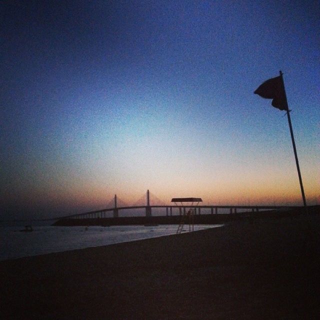 sea, clear sky, copy space, sunset, horizon over water, water, tranquility, tranquil scene, scenics, beach, silhouette, transportation, nature, beauty in nature, sky, dusk, outdoors, built structure, pier, connection