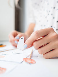 Midsection of woman making craft at home