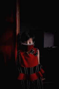 Girl wearing mask while standing at home