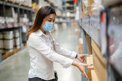 Midsection of woman standing at store