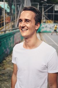 Portrait of smiling young man standing outdoors