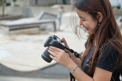 Side view of woman photographing