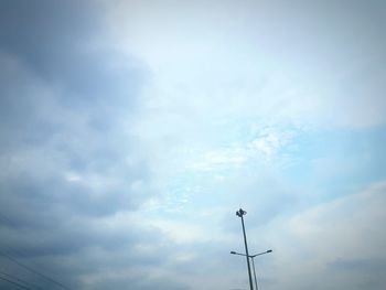 Low angle view of telephone pole against sky