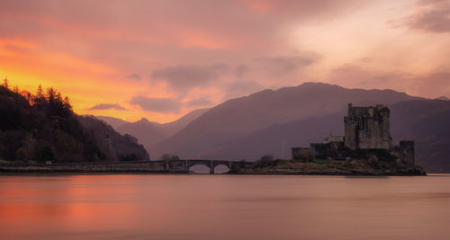 Scenic view of lake against orange sky