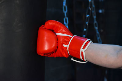 Cropped image of hand wearing red boxing glove