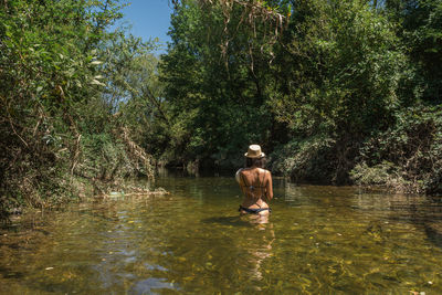 Full length of woman in lake in forest