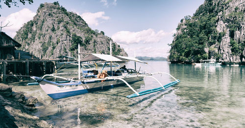 Boats moored in sea against sky