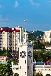 Buildings in city against blue sky