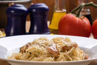 Close-up of spaghetti with carbonara in plate on table