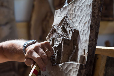 Close-up of craftsperson making sculpture at workshop