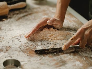 Cropped image of man working on cutting board