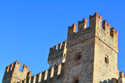 Low angle view of historic building against blue sky