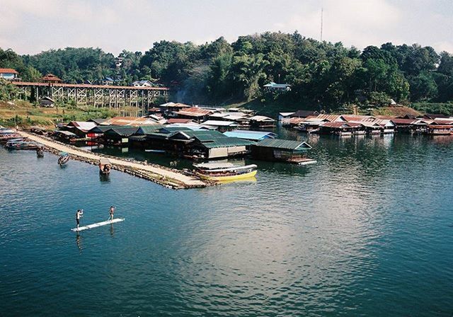 water, transportation, nautical vessel, mode of transport, boat, tree, waterfront, sky, moored, river, lake, nature, tranquil scene, tranquility, built structure, day, scenics, outdoors, mountain, harbor