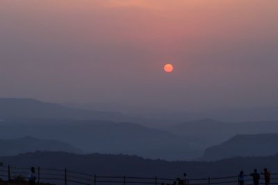 Scenic view of silhouette mountains against sky at sunset