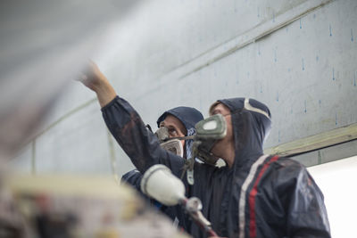 Factory worker in truck manufacture preparing truck to be spray painted