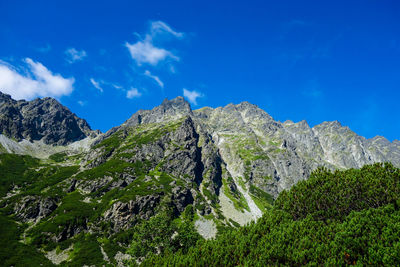 Scenic view of mountains against blue sky