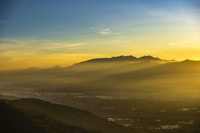 Scenic view of silhouette mountains against sky during sunset