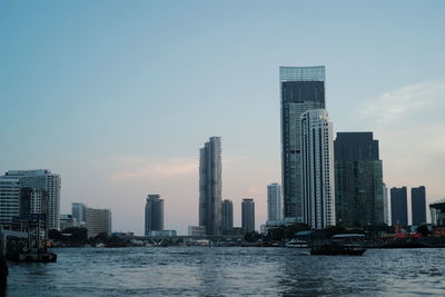 Modern buildings in city against clear sky