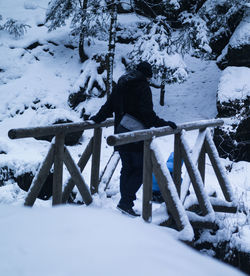 Man standing on snow covered landscape