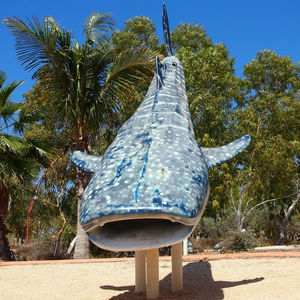 Close-up of palm tree against blue sky