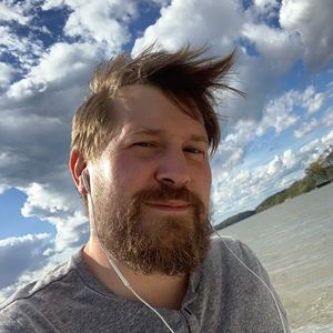 Portrait of young man against sky