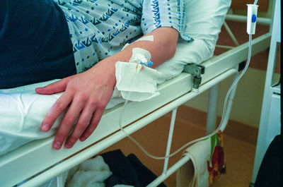 Midsection of man lying on hospital bed