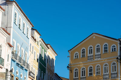 Low angle view of buildings against blue sky