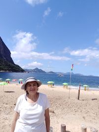 Senior woman standing at beach