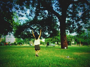 People walking on grassy field in park