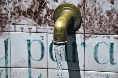 Close-up of faucet against wall