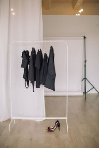 Clothes hanging on rack in studio