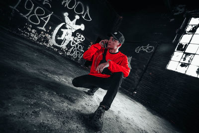 Side view of young man on red floor