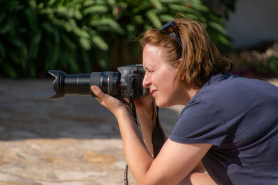 Portrait of woman photographing