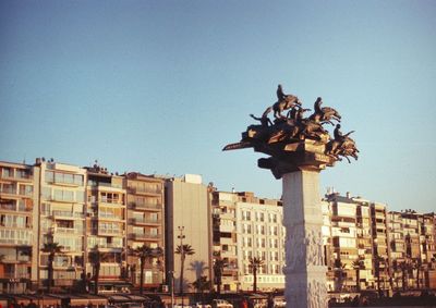 Low angle view of buildings against clear blue sky