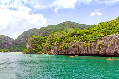 Scenic view of sea and mountains against sky