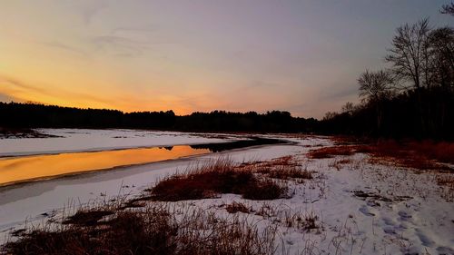 Scenic view of lake against sky during sunset