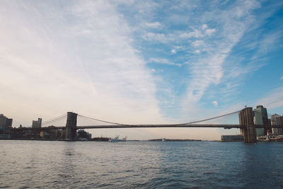 Brooklyn bridge over east river against sky