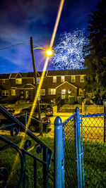 Illuminated built structure against blue sky at night