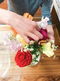 Midsection of woman holding rose bouquet