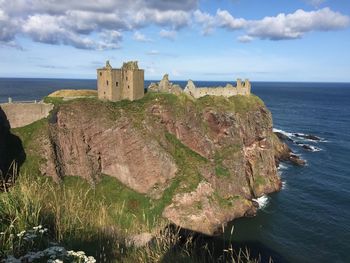 Castle by sea against sky